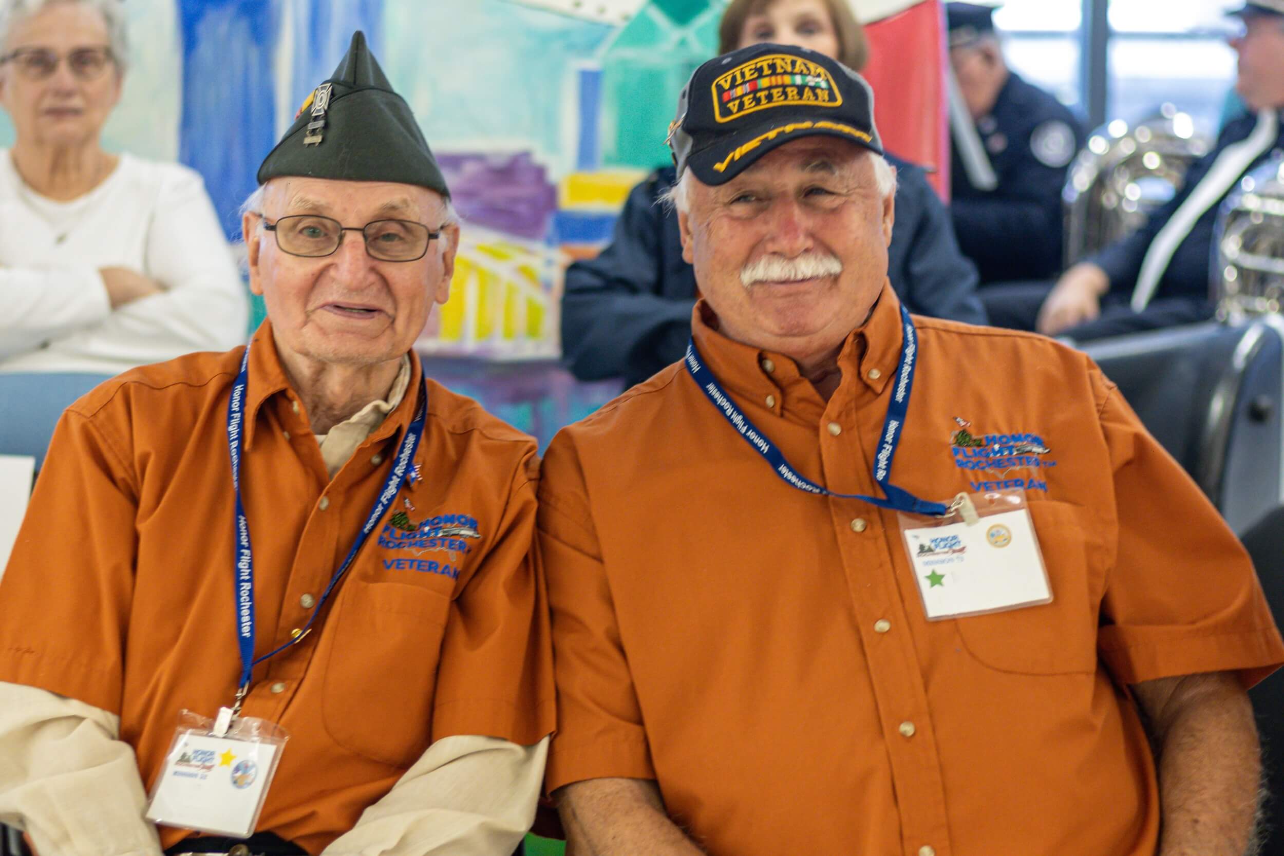 Two veterans sitting at Welcome Home Ceremony